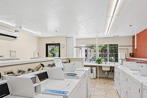 A white office with a clock on the wall.
