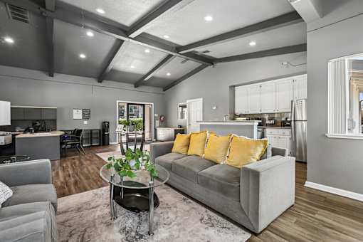 Leasing Office at Bent Tree with plush couches, high ceillings, a kitchen, and leasing staff ready to help you find your dream home, or assist residents.