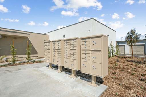 Outdoor mailbox units with residential buildings at Altitude Apartments, California
