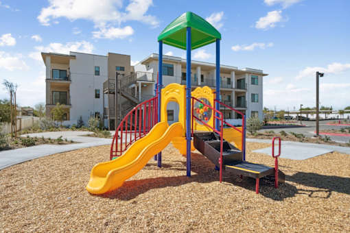 Colorful playground with slide and climbing structure at Altitude Apartments, Moreno Valley, CA 92553