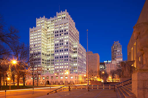 A large building with many windows is lit up at night.