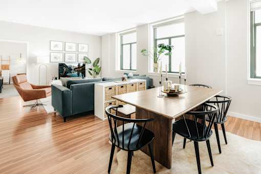 A modern living room with a wooden floor and furniture.