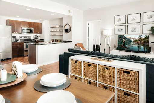 A modern kitchen with a dining table set for two.