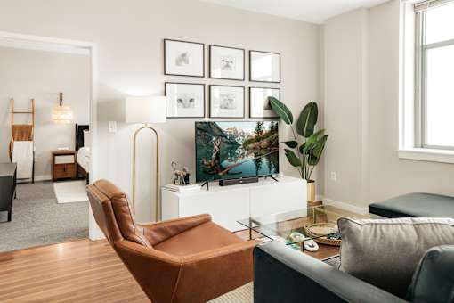 A living room with a brown leather chair and a television.