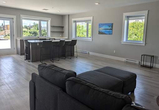 a common area with a couch and a kitchen with a bar
