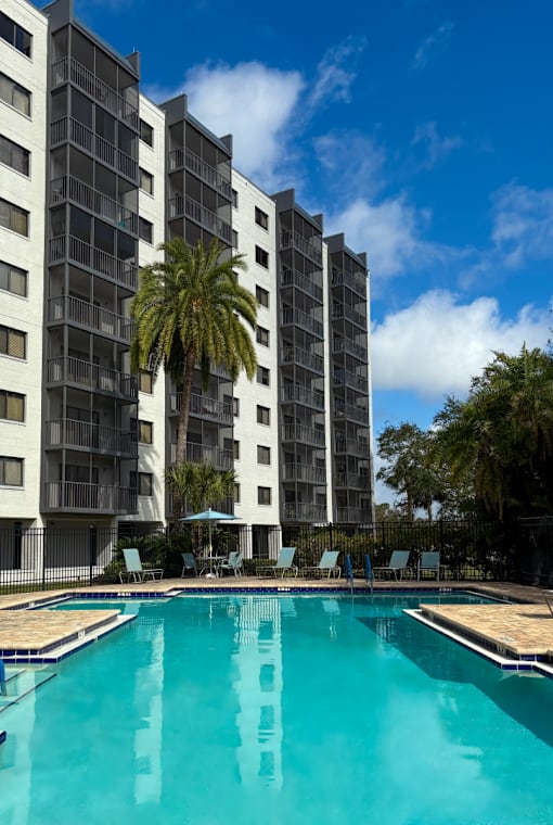 A tall building with a pool at Hampton Apartments, Clearwater, FL, 33759