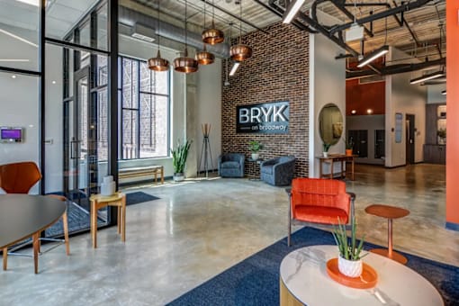 A modern office space with a brick wall and the name "BRYK" on it.