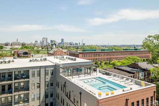 the pool on the roof of a building with a city in the background at 1400 Russell Apartments, Saint Louis, Missouri