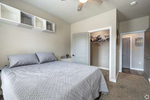 a bedroom with a bed and a closet and a ceiling fan at 1400 Russell Apartments, Missouri