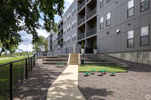 an apartment building with stairs and grass in front of it at 1400 Russell Apartments, Saint Louis