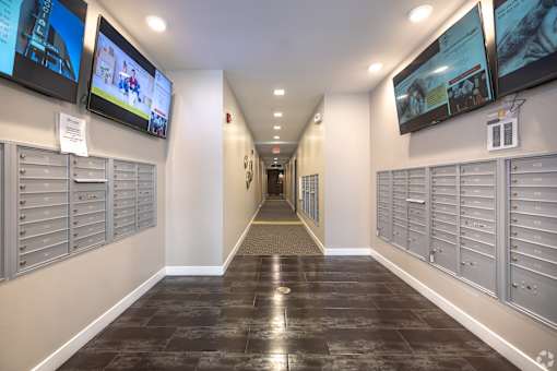 a hallway with mailboxes and televisions in a building at 1400 Russell Apartments, Saint Louis, MO
