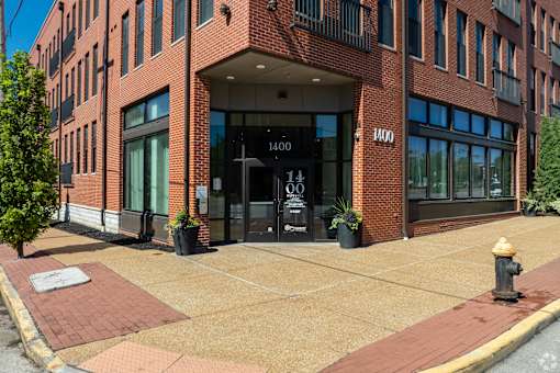a brick building with a fire hydrant in front of it at 1400 Russell Apartments, Saint Louis, MO