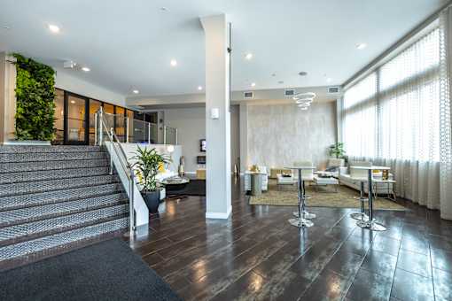 a lobby with a reception area and a staircase at 1400 Russell Apartments, Saint Louis, Missouri
