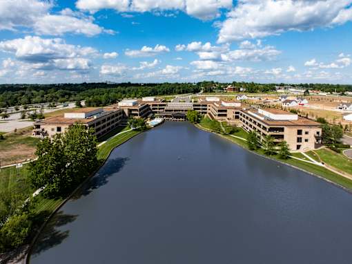 A large body of water is surrounded by buildings. at The Residences at Tesson Ridge Apartments, Saint Louis, 63128