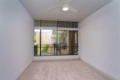 A room with a ceiling fan and a window with blinds. at The Residences at Tesson Ridge Apartments, Saint Louis