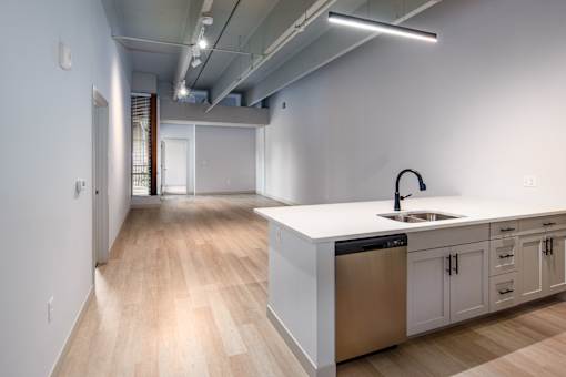 A modern kitchen with a white countertop and stainless steel appliances. at The Residences at Tesson Ridge Apartments, Saint Louis, MO, 63128