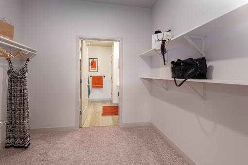 A room with a door and a wall-mounted shelf with a bag on it. at The Residences at Tesson Ridge Apartments, Saint Louis, 63128
