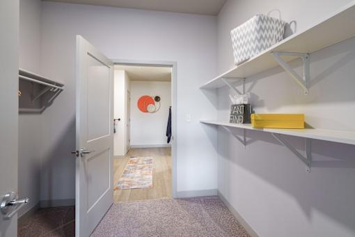 A hallway with a white door and a yellow box on a shelf. at The Residences at Tesson Ridge Apartments, Saint Louis, 63128