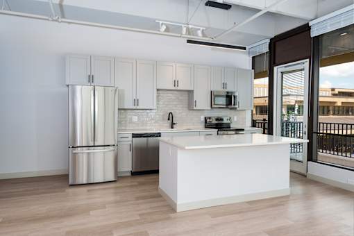 A modern kitchen with white cabinets and stainless steel appliances. at The Residences at Tesson Ridge Apartments, Saint Louis