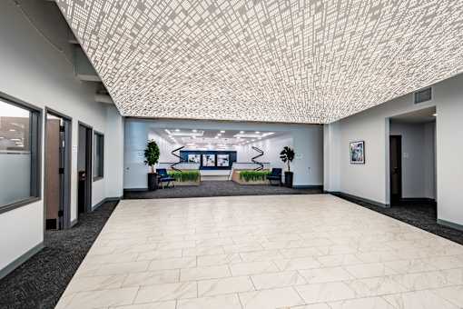 A hallway with a tiled ceiling and a bench with a blue cushion. at The Residences at Tesson Ridge Apartments, Saint Louis, 63128