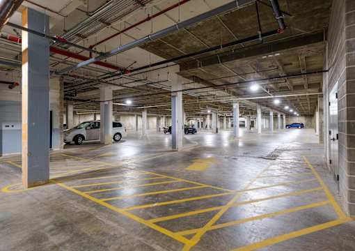 A parking garage with yellow lines on the floor. at The Residences at Tesson Ridge Apartments, Saint Louis, Missouri