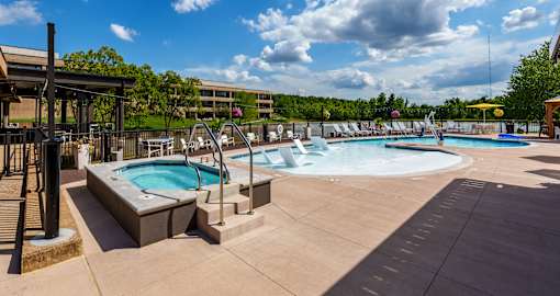 A large outdoor swimming pool with a hot tub and a water slide. at The Residences at Tesson Ridge Apartments, Saint Louis, 63128