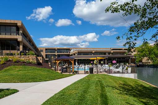 A building with a pool in front of it. at The Residences at Tesson Ridge Apartments, Saint Louis, MO, 63128