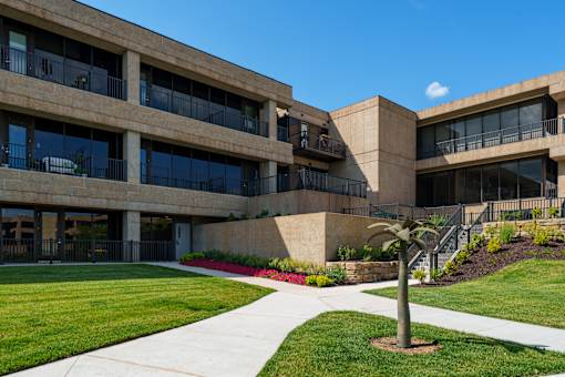 A building with a palm tree in front at The Residences at Tesson Ridge Apartments, Saint Louis