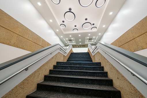 A staircase with a metal railing and wooden steps. at The Residences at Tesson Ridge Apartments, Missouri, 63128