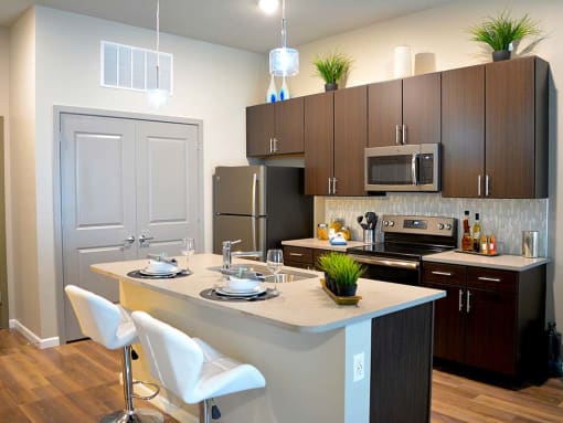 Kitchen with wooden cabinets at The Villages of Twin Oaks, Twin Oaks, MO
