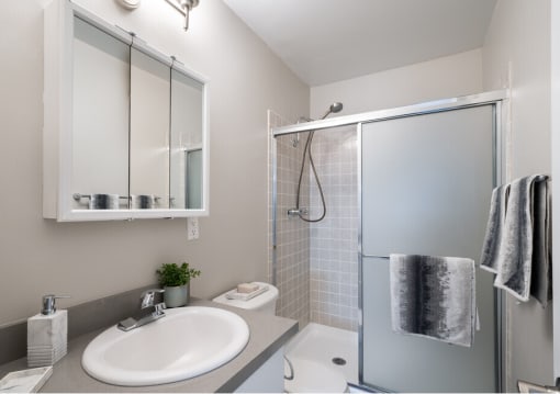 a bathroom with a sink shower and toilet in a 555 waverly unit
