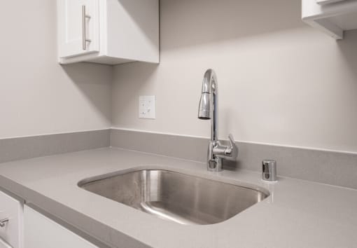 a kitchen sink with a faucet in a 555 waverly unit