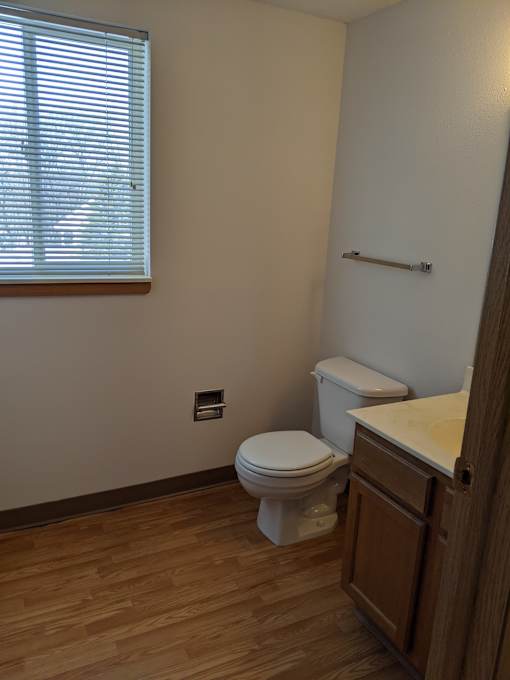 an image of a bathroom with a toilet sink and a window