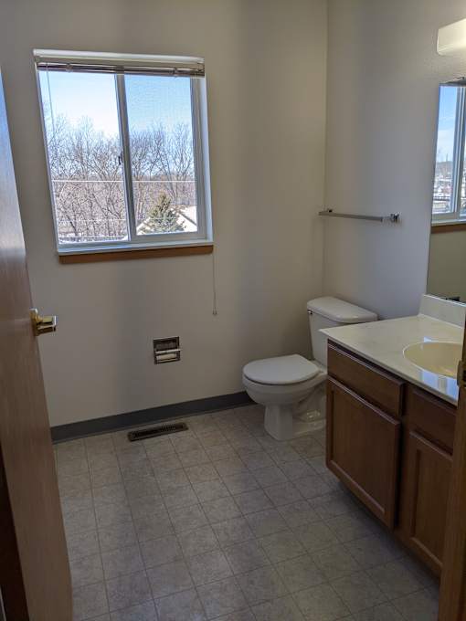 a bathroom with a toilet sink and a window
