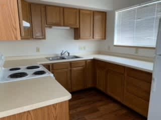 a kitchen with a stove top oven next to a window