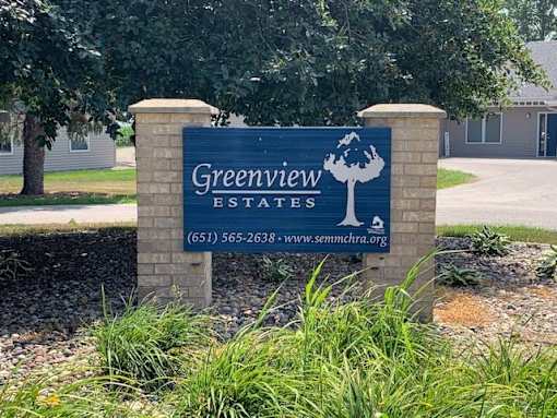 a sign in front of a house that says greenview estates