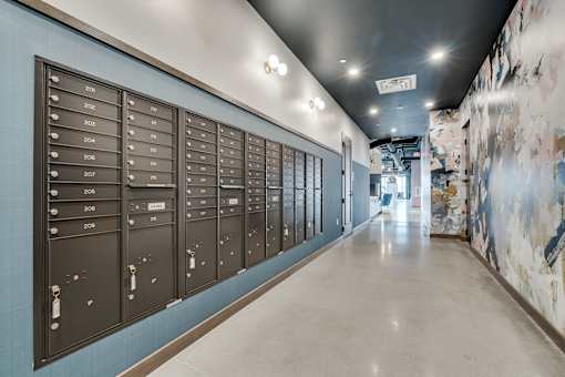 A long hallway with mailboxes on the wall. at The Shale, Minneapolis