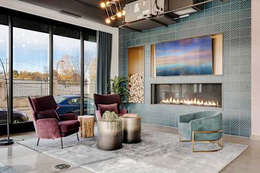 A room with a fireplace and a painting on the wall. at The Shale, Minnesota, 55406