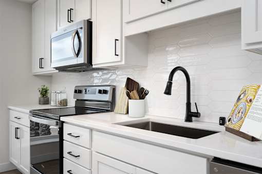 A modern kitchen with a black and white color scheme. at The Shale, Minnesota, 55406