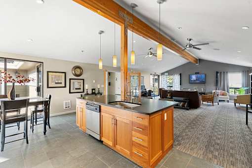 A modern kitchen with wooden cabinets and a large island.