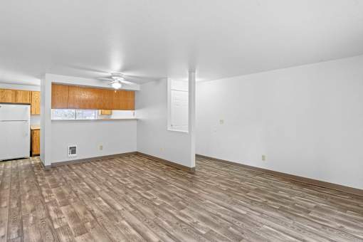 A room with wooden flooring and white walls.
