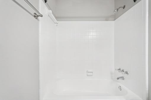 A white bathroom with a tub and shower.