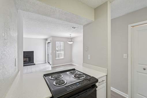 A black stove top oven in a white kitchen.