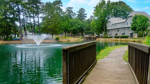 A view of the lake with a fountain and our apartment homes in the background