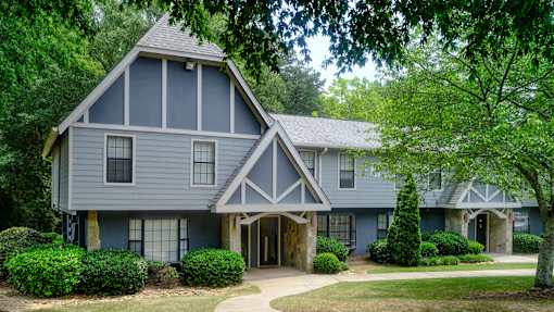 The front of one of the homes with a blue and white paint and stone exterior
