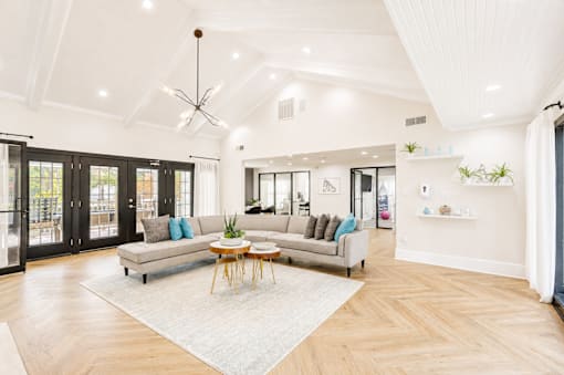 A spacious living room with a large sofa and a coffee table.
