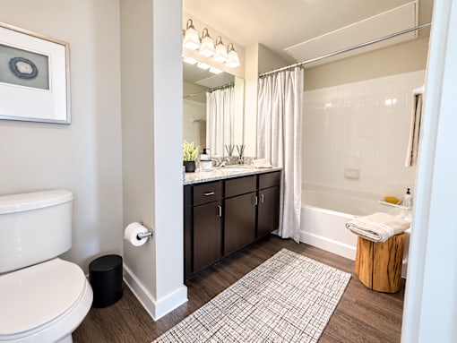 A bathroom with a toilet, sink, and bathtub.