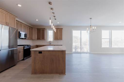 A kitchen with wooden cabinets and a central island.