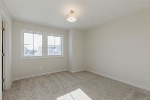 A room with a window and a door.