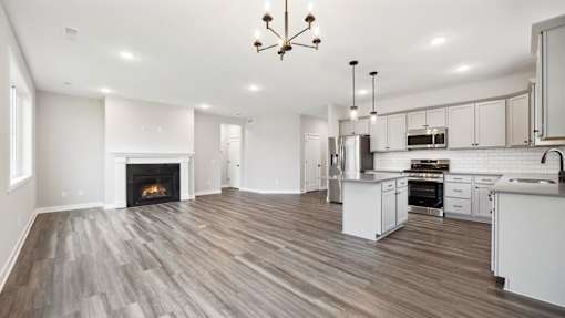 A spacious kitchen and living room with a fireplace.